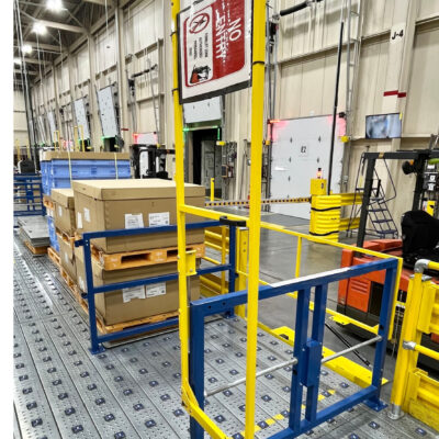 A WorkZone safety gate with diamond plate flooring separates employees from vehicle traffic in material handling facilities