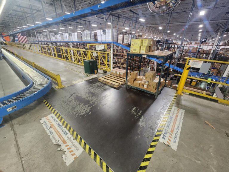 a material handling facility with a pallet drop area that is located on a ledge that has no fall protection