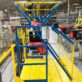 An industrial safety gate in a facility at a ledge in a AutoStore system will provide fall protection for employees working at the port,